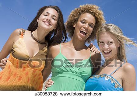 Three women posing outdoors View Large Photo Image Stock Photo - Three women posing outdoors. Fotosearch
