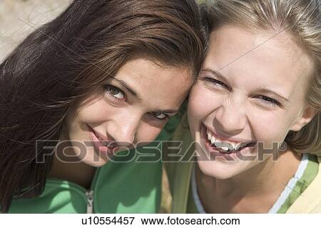 Stock Photo - Two young women posing outdoors. Fotosearch