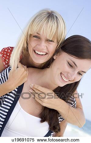 Two young women posing outdoors View Large Photo Image Stock Photography - Two young women posing outdoors. Fotosearch