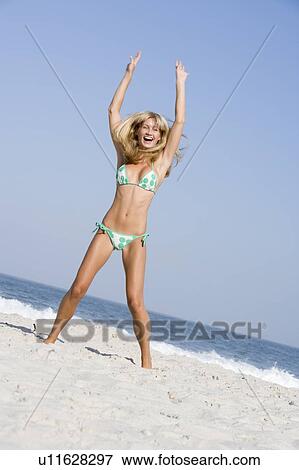 Woman in a two piece bathing suit posing on a beach View Large Photo Image Stock Photo - Woman in a two piece bathing suit posing on a beach. Fotosearch