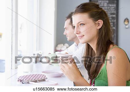 Young couple having tea in a cafeteria View Large Photo Image Stock Photography - Young couple having tea in a cafeteria. Fotosearch