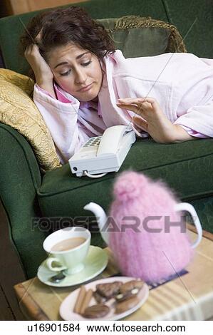 Young woman at home waiting by telephone View Large Photo Image Picture - Young woman at home waiting by telephone. Fotosearch