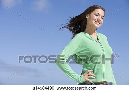 Young woman posing outdoors View Large Photo Image Stock Image - Young woman posing outdoors. Fotosearch