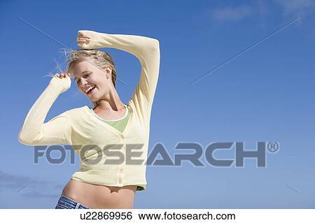 Young woman posing outdoors View Large Photo Image Stock Photograph - Young woman posing outdoors. Fotosearch