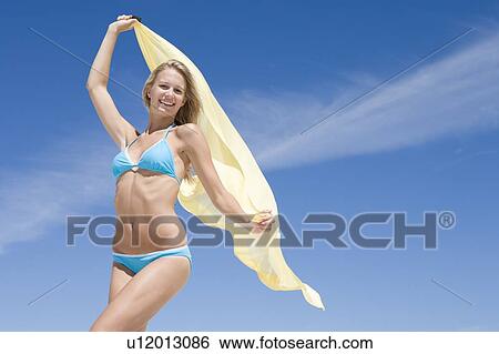 Stock Photograph - Young woman posing with a scarf. Fotosearch