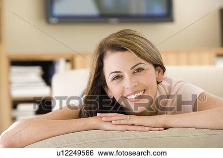 Woman lying in living room View Large Photo Image Stock Photograph - Woman lying in living room. Fotosearch