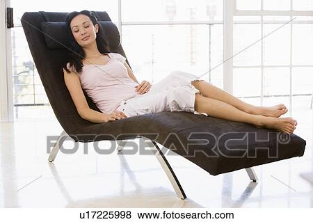 Stock Photo - Woman sitting in chair sleeping. Fotosearch
