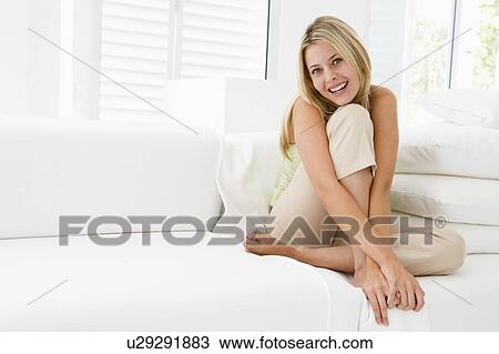 Woman sitting in living room View Large Photo Image Stock Image - Woman sitting in living room. Fotosearch