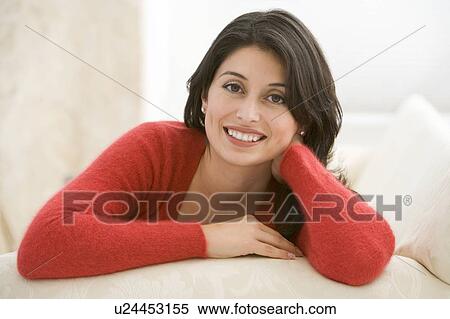 Woman sitting in living room View Large Photo Image Stock Photography - Woman sitting in living room. Fotosearch