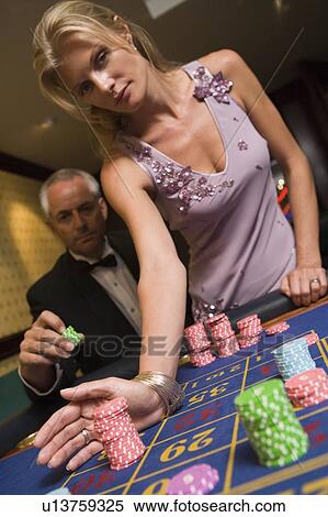Couple in casino playing roulette (selective focus) View Large Photo Image Stock Photography - Couple in casino playing roulette (selective focus). Fotosearch