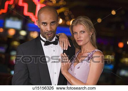 Couple in casino with cigar (selective focus) View Large Photo Image Stock Photograph - Couple in casino with cigar (selective focus). Fotosearch