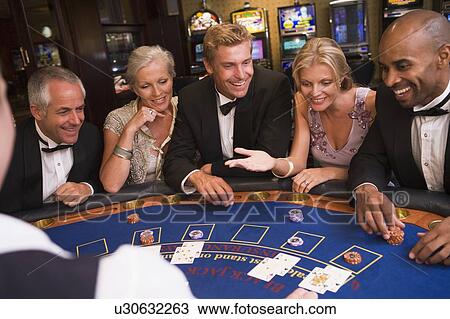Five people in casino playing blackjack and smiling (selective focus) View Large Photo Image Stock Image - Five people in casino playing blackjack and smiling (selective focus). Fotosearch