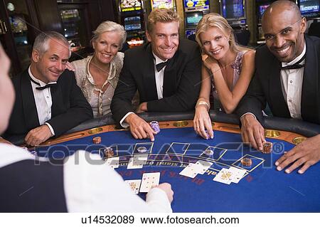 Five people in casino playing blackjack and smiling (selective focus) View Large Photo Image Stock Photo - Five people in casino playing blackjack and smiling (selective focus). Fotosearch