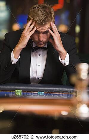 Man in casino playing roulette and losing (selective focus) View Large Photo Image Stock Image - Man in casino playing roulette and losing (selective focus). Fotosearch