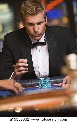 Man in casino playing roulette (selective focus) View Large Photo Image Stock Image - Man in casino playing roulette (selective focus). Fotosearch