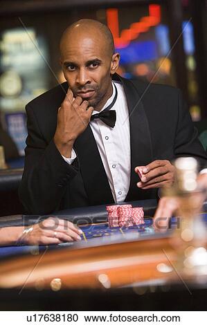 Man in casino playing roulette (selective focus) View Large Photo Image Stock Image - Man in casino playing roulette (selective focus). Fotosearch