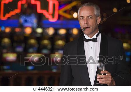 Man in casino with cigar and champagne (selective focus) View Large Photo Image Stock Image - Man in casino with cigar and champagne (selective focus). Fotosearch