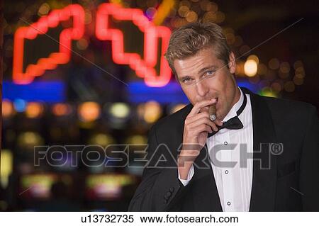 Stock Photography - Man in casino with cigar (selective focus). Fotosearch