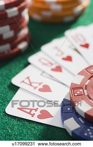 Playing cards making royal flush in hearts by poker chips (close up/selective focus) View Large Photo Image Stock Image - Playing cards making royal flush in hearts by poker chips (close up/selective focus). Fotosearch