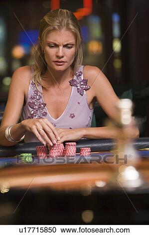 Woman in casino playing roulette and thinking (selective focus) View Large Photo Image Stock Image - Woman in casino playing roulette and thinking (selective focus). Fotosearch
