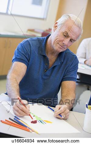 Adult student in class drawing picture View Large Photo Image Picture - Adult student in class drawing picture. Fotosearch