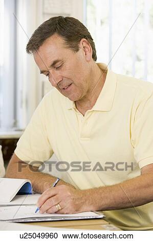 Stock Image - Adult student studying at table. Fotosearch