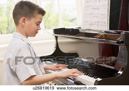 Stock Photo - Boy Playing Piano. Fotosearch