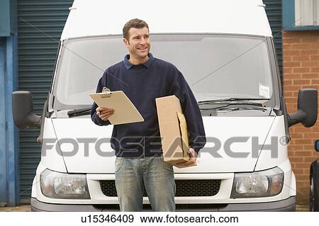 Deliveryperson standing with van holding clipboard and box smiling View Large Photo Image Stock Photo - Deliveryperson standing with van holding clipboard and box smiling. Fotosearch