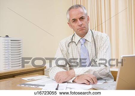 Stock Photography - Doctor with laptop in doctor's office. Fotosearch