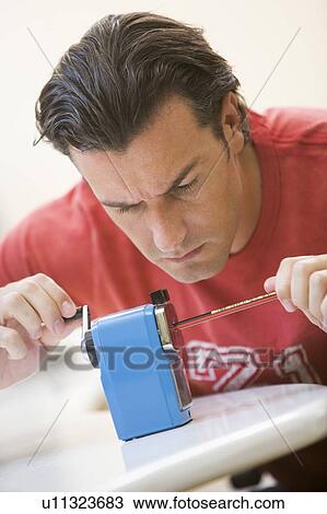 Man indoors using pencil sharpener View Large Photo Image Stock Image - Man indoors using pencil sharpener. Fotosearch