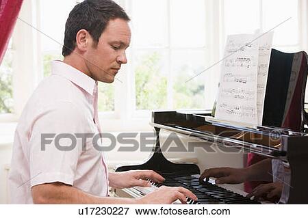 Stock Photo - Man playing piano. Fotosearch