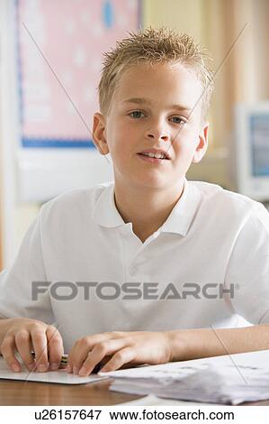 Stock Photo - Student in class taking notes. Fotosearch