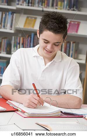 Stock Image - Student writing and studying. Fotosearch