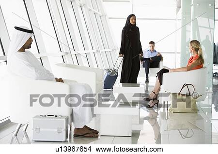 Picture - Airline passengers waiting in departure gate. Fotosearch
