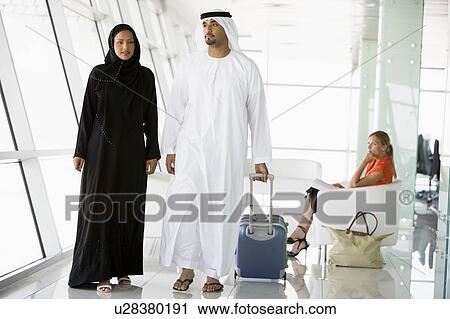 Stock Image - Airline passengers waiting in departure gate. Fotosearch