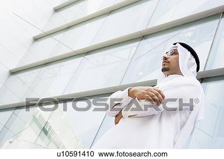 Businessman standing outdoors by building (selective focus) View Large Photo Image Stock Image - Businessman standing outdoors by building (selective focus). Fotosearch