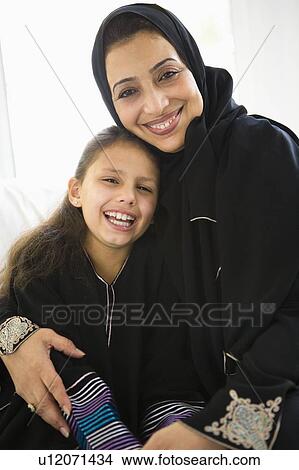 Grandmother with grandaughter in living room smiling View Large Photo Image Picture - Grandmother with grandaughter in living room smiling. Fotosearch
