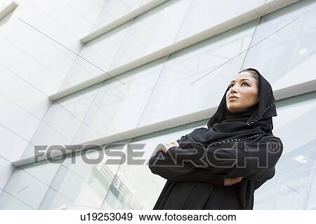 Businesswoman standing outdoors by building (selective focus) View Large Photo Image Stock Photo - Businesswoman standing outdoors by building (selective focus). Fotosearch