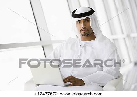 Man indoors with laptop (high key/selective focus) View Large Photo Image Stock Image - Man indoors with laptop (high key/selective focus). Fotosearch