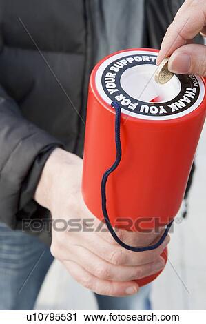 Stock Image - Donating Money To Charity. Fotosearch