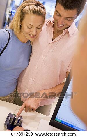 Stock Photo - Man paying for purchases with credit card. Fotosearch