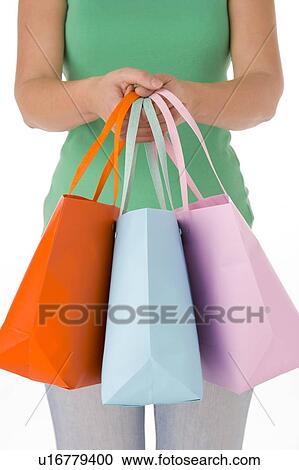 Stock Image - Woman Holding Shopping Bags. Fotosearch