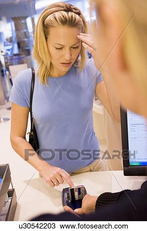 Woman trying to remember credit card PIN number View Large Photo Image Stock Image - Woman trying to remember credit card PIN number. Fotosearch