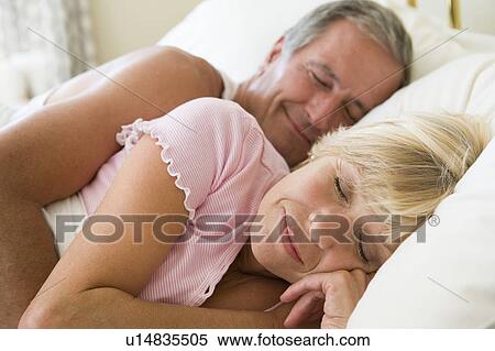 Stock Photography - Couple lying in bed sleeping. Fotosearch