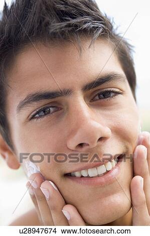 Man applying shaving cream smiling View Large Photo Image Picture - Man applying shaving cream smiling. Fotosearch