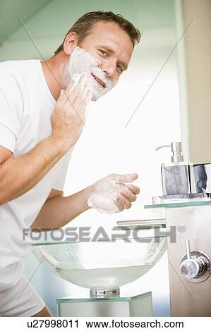 Man in bathroom shaving View Large Photo Image Stock Image - Man in bathroom shaving. Fotosearch
