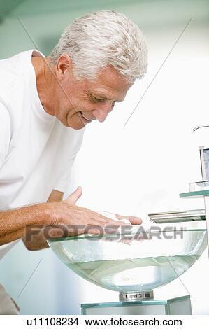 Picture - Man in bathroom with shaving cream smiling. Fotosearch