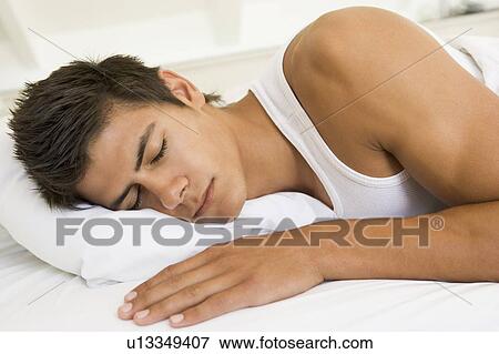 Man lying in bed sleeping View Large Photo Image Stock Photo - Man lying in bed sleeping. Fotosearch