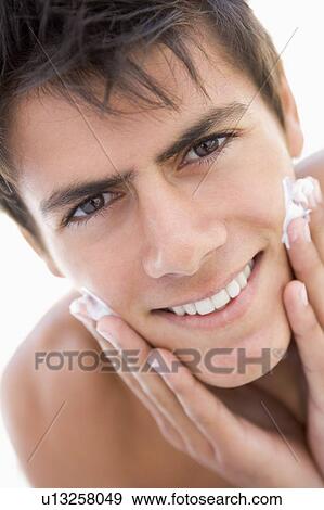 Man putting on shaving cream smiling View Large Photo Image Stock Photo - Man putting on shaving cream smiling. Fotosearch