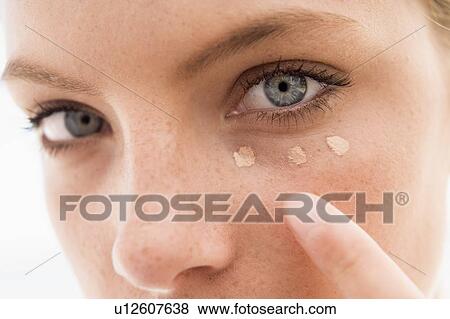 Woman applying concealer View Large Photo Image Stock Photo - Woman applying concealer. Fotosearch